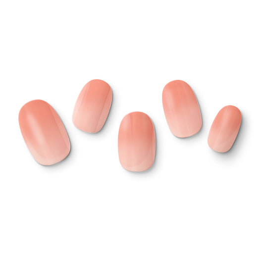 The gel nail wraps of ManiTini 'Youthful Peach' showcasing delicate and understated soft tones blossoming on your fingertips like a youthful peach orchard.