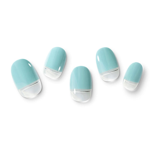 The gel nail wraps of ManiTini 'Seaside on the Edge' showcasing the shimmering silver thread, resembling the horizon that divides the sea and the shore.