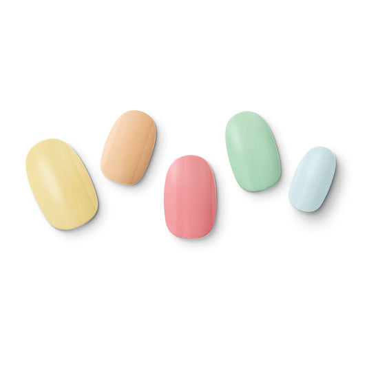 The gel nail wraps of ManiTini 'Fruity Cream' showcasing fingertips dipped in a rainbow of fruity cream.