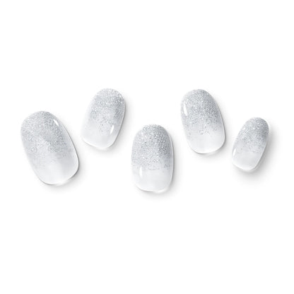 The gel nail wraps of ManiTini 'Silver Sea Soiree' showcasing the boundless silver sea shining and dazzling, igniting the desire to dive into a vibrant and lively party.