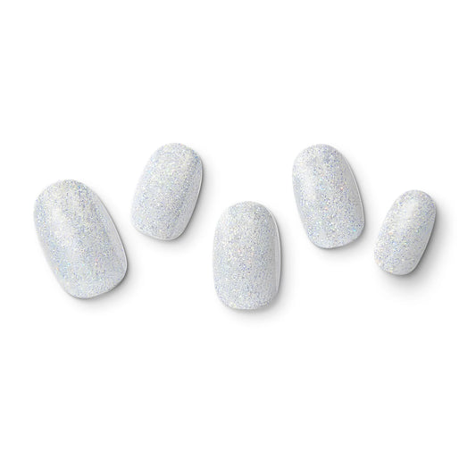 The gel nail wraps of ManiTini 'Twinkling Cascade' showcasing the radiance of thousands of stars, creating a shimmering cascade of silver light.