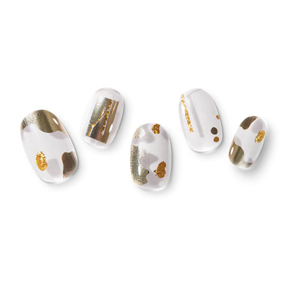 The gel nail wraps of ManiTini 'Golden Ode to Joy' showcasing irregular golden confetti explodes with great joy and brilliance.