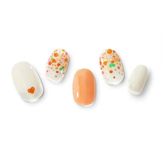 The gel nail wraps of ManiTini 'Champagne Bubblescape' showcasing lively orange hearts and bubbles ascend in the enchanted Champagne, whisking you away to a dreamy world of whimsy and wonder.